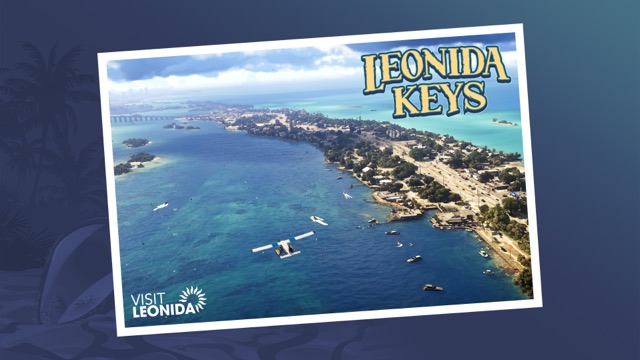 Official Visit Leonida postcard of the Leonida Keys: an aerial view of a narrow island with boats and a seaplane in bright blue water.