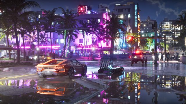 An orange sports car on a rain-soaked, neon-lit Vice City street at night, outside the Ocean View Hotel and Hotel Dixon